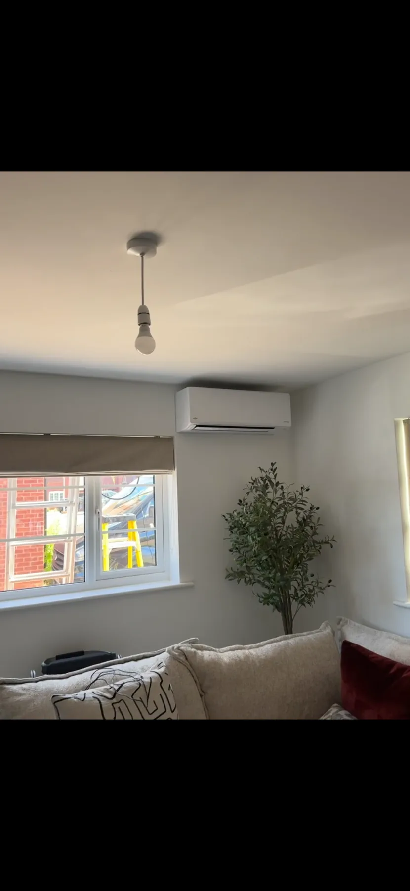 Completed wall-mounted air conditioning installation in a living room